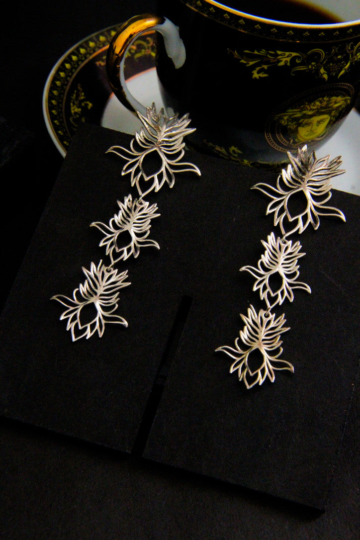 A pair of silver eucomis earrings shaped like pineapple flowers. handcrafted in sterling silver